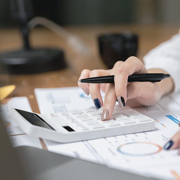 Person using calculator on financial documents